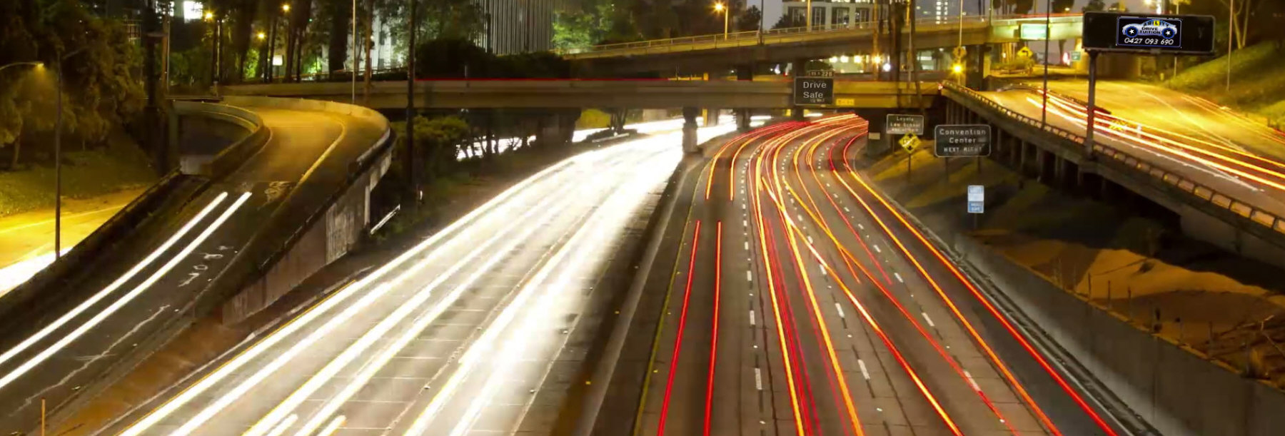 Overhead photo of time lapse, busy traffic driving on freeway